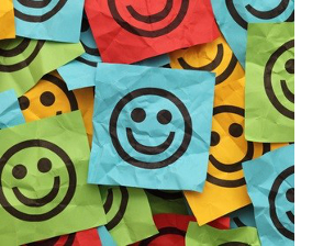 Colorful crumpled adhesive notes with smiling faces.