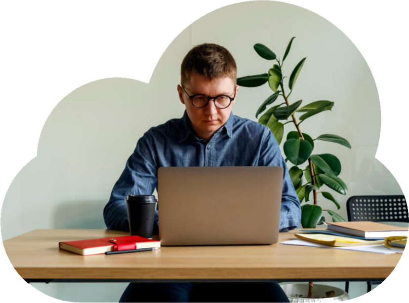 Man sitting at a desk working on his laptop