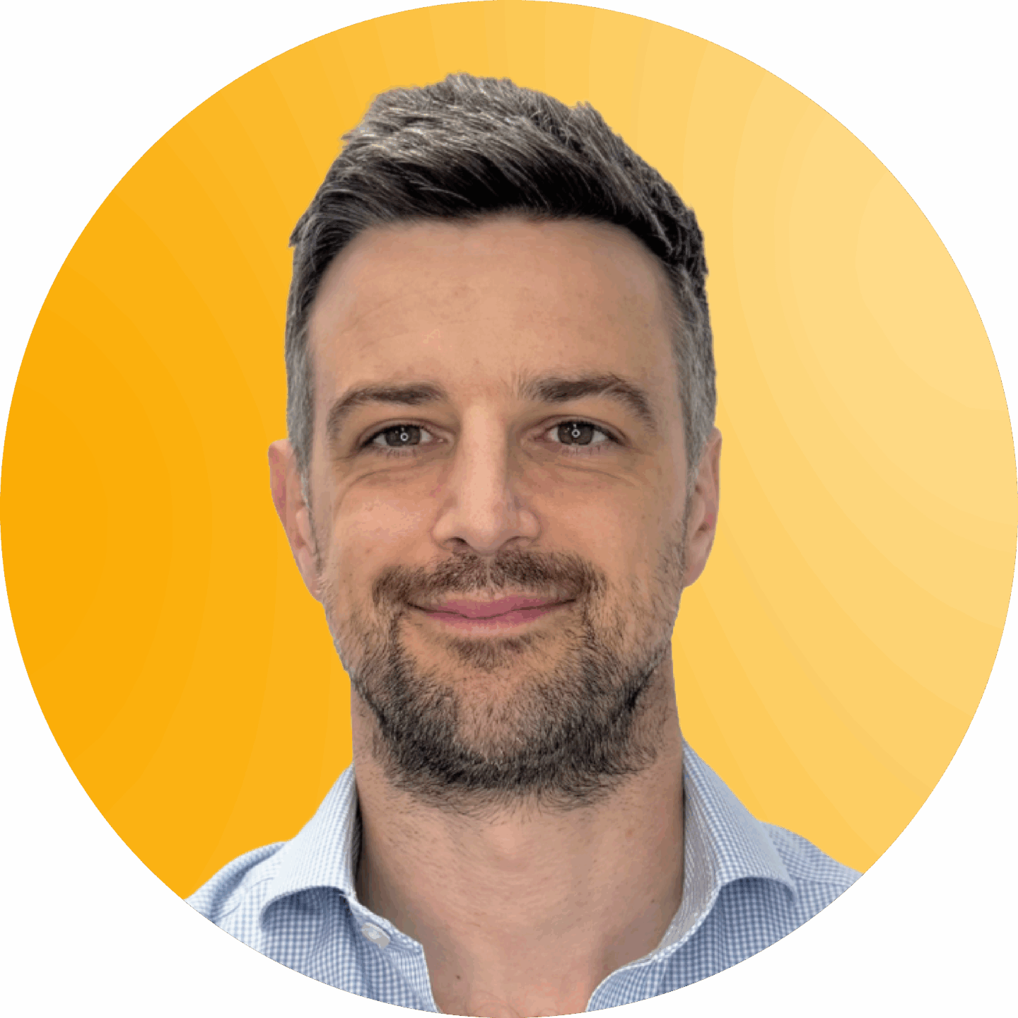 Dan Musto, Director at Fetch Recruitment in a blue and while checkered shirt against a yellow background.