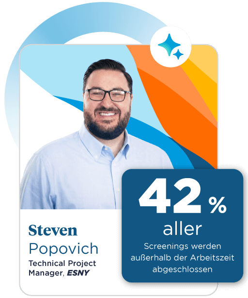 A smiling man with black hair is wearing a blue oxford shirt and glasses, set against a colorful background of blue, orange, and yellow.