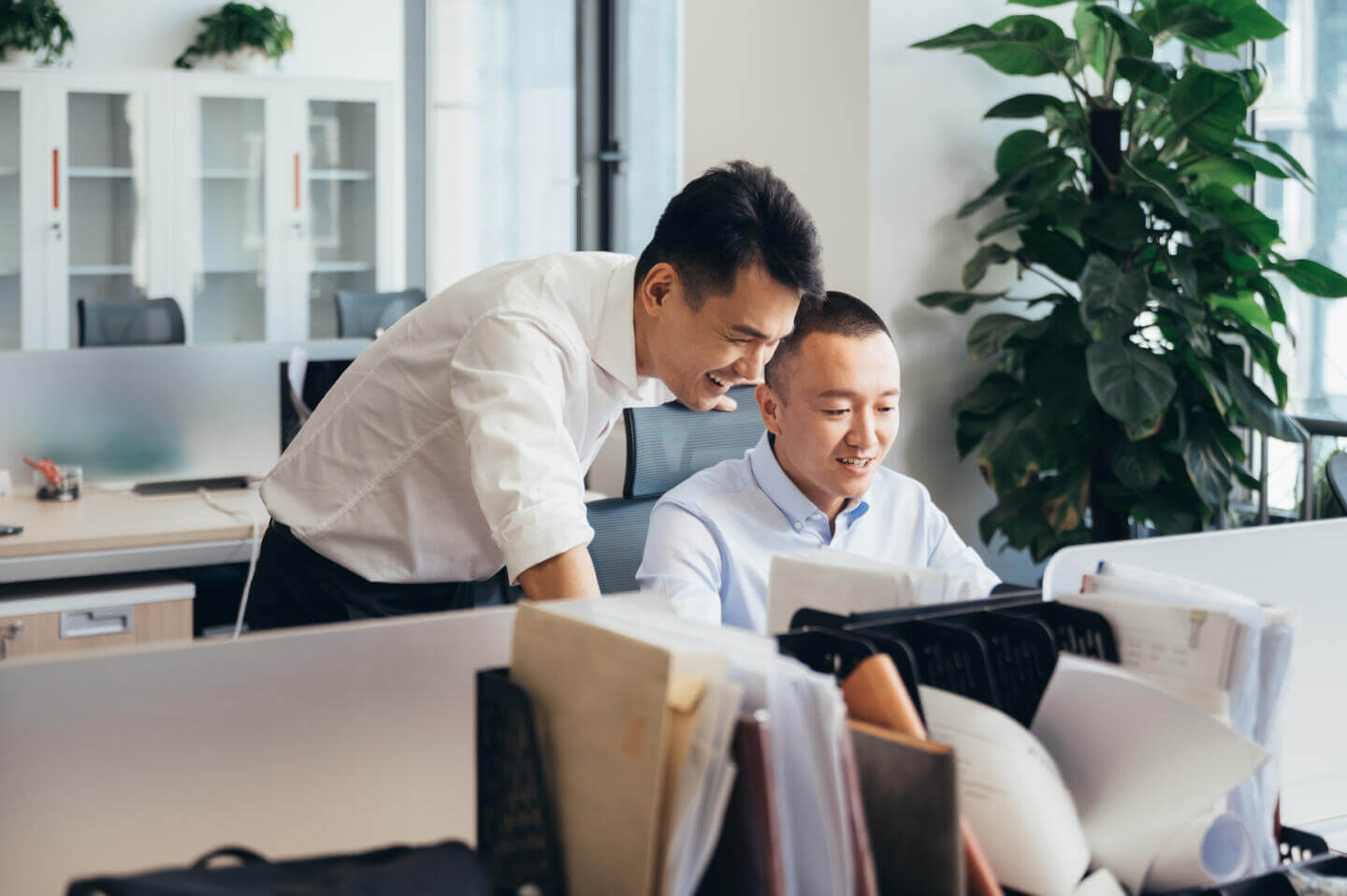 Two employees from a recruitment agency looking in a tablet at Bullhorn, the best recruitment agency software.