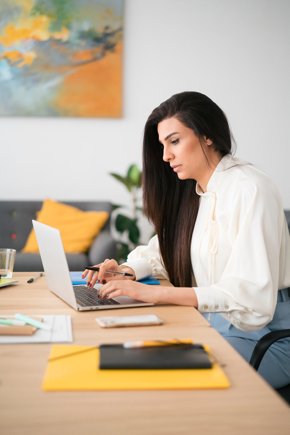 Footer Focused Female Working On Laptop In Office