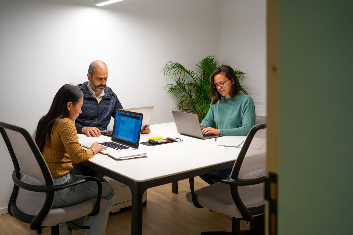 two people working together in a conference room