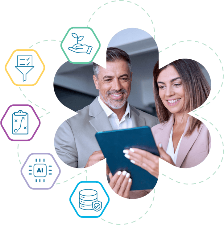 A man and woman focus on a tablet with surrounding icons, representing Bullhorn Automation for staffing agency solutions.