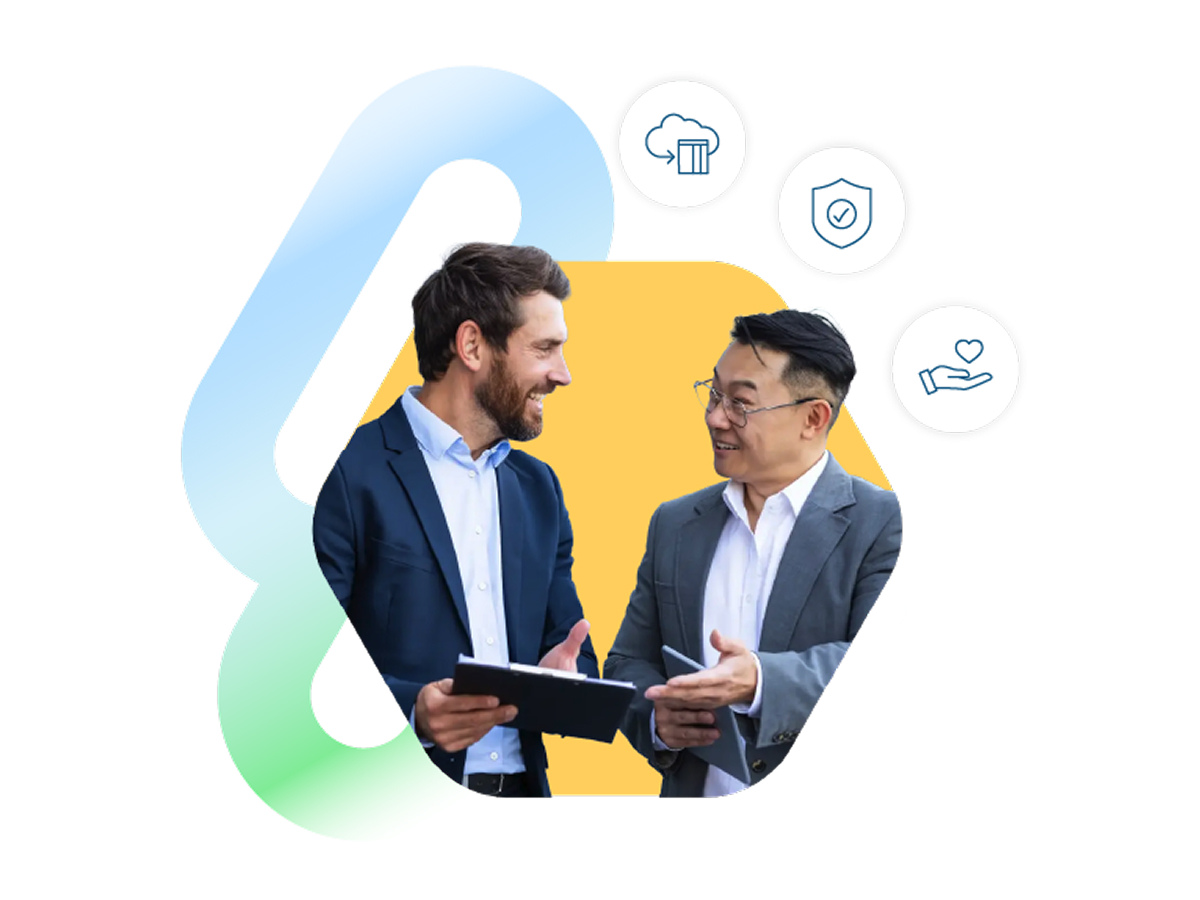 Two men in business suits converse, smiling warmly, holding tablets. Above them are icons of a cloud, shield, and hand, symbolizing technology and security.